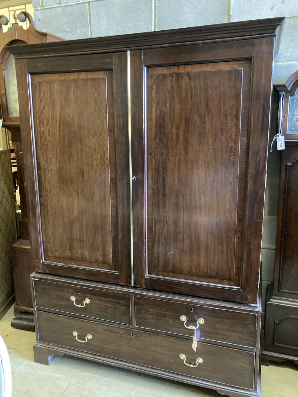 A George III mahogany panelled linen press, width 135cm, depth 62cm, height 190cm